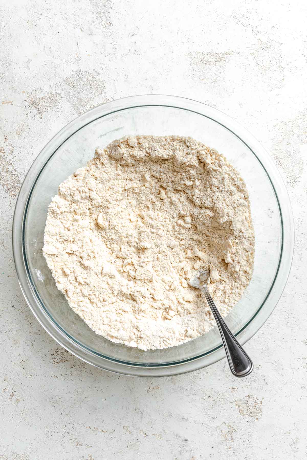 Process shot showing mixing ingredients together in a bowl.