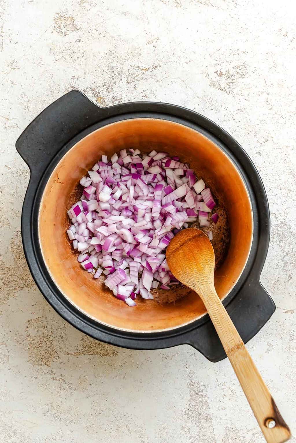Process shot showing stirring ingredients in a pot.