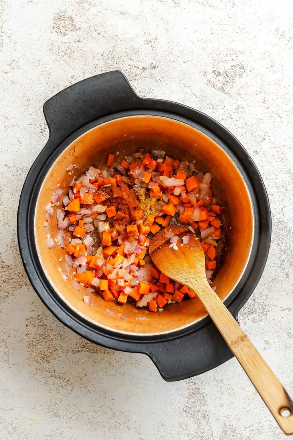 Process shot showing stirring ingredients in a pot.