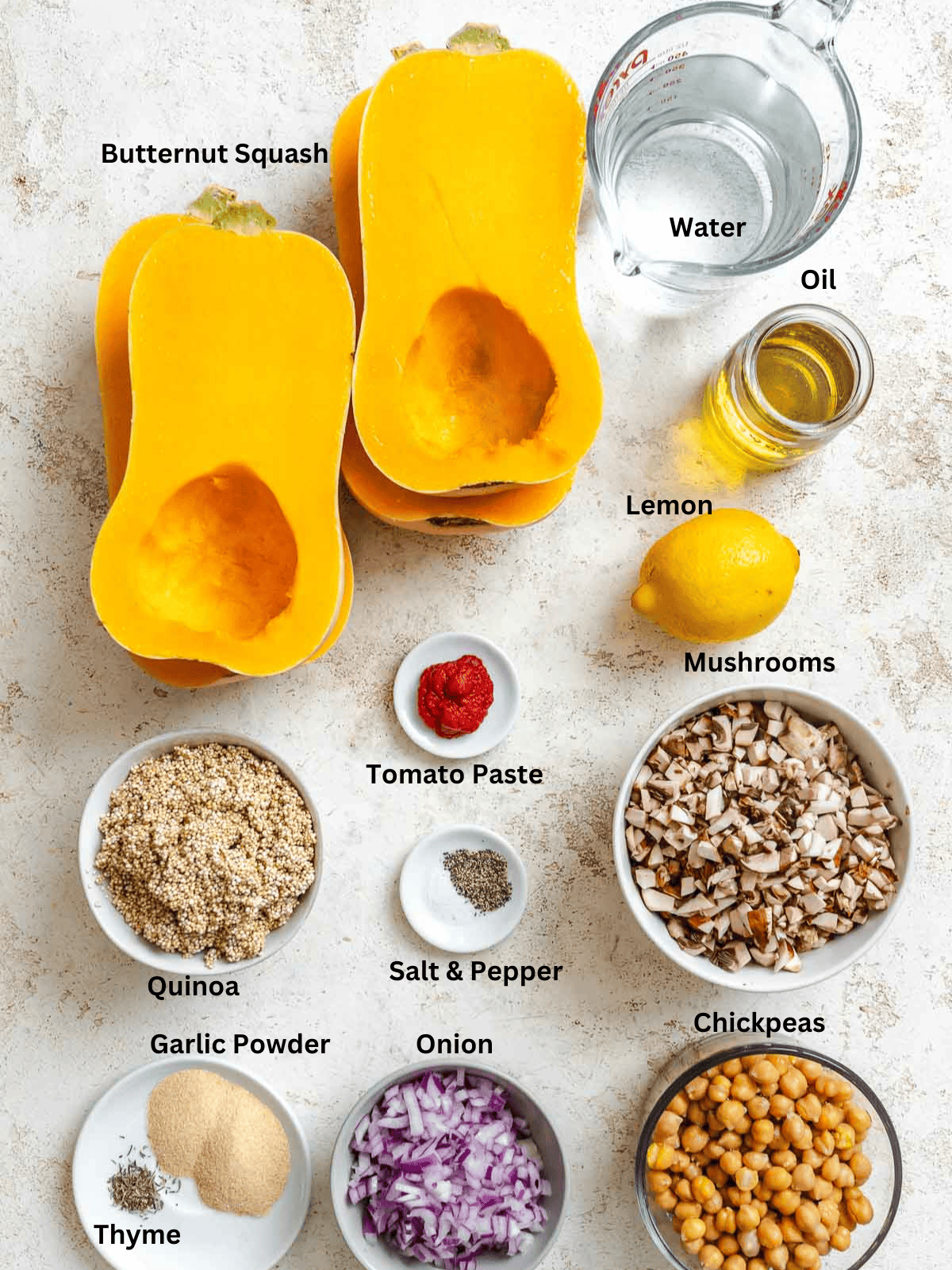 Ingredients for Vegan Stuffed Butternut Squash measured out on a white surface.