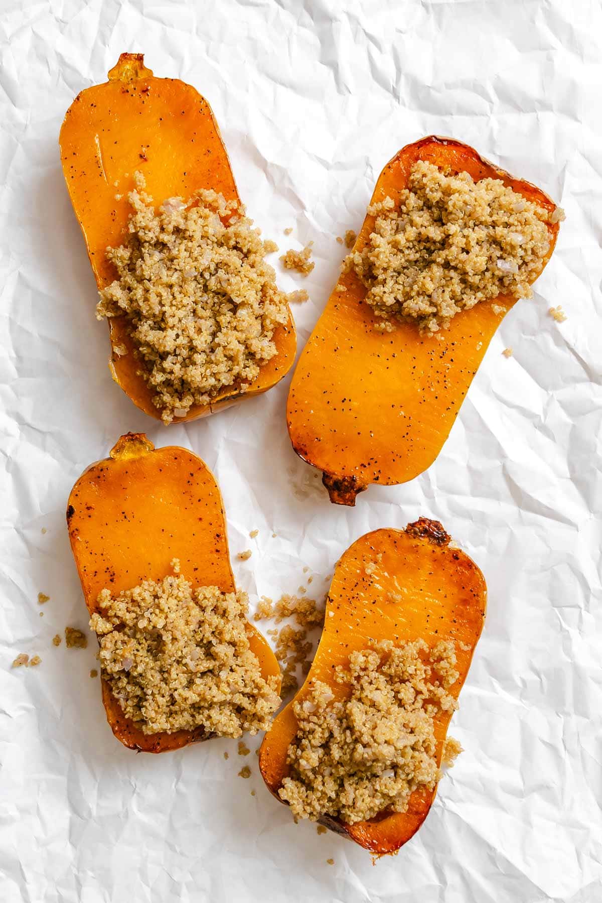 Process shot showing adding filling to butternut squash.