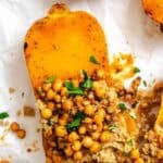 Completed Vegan Stuffed Butternut Squash on a white surface.