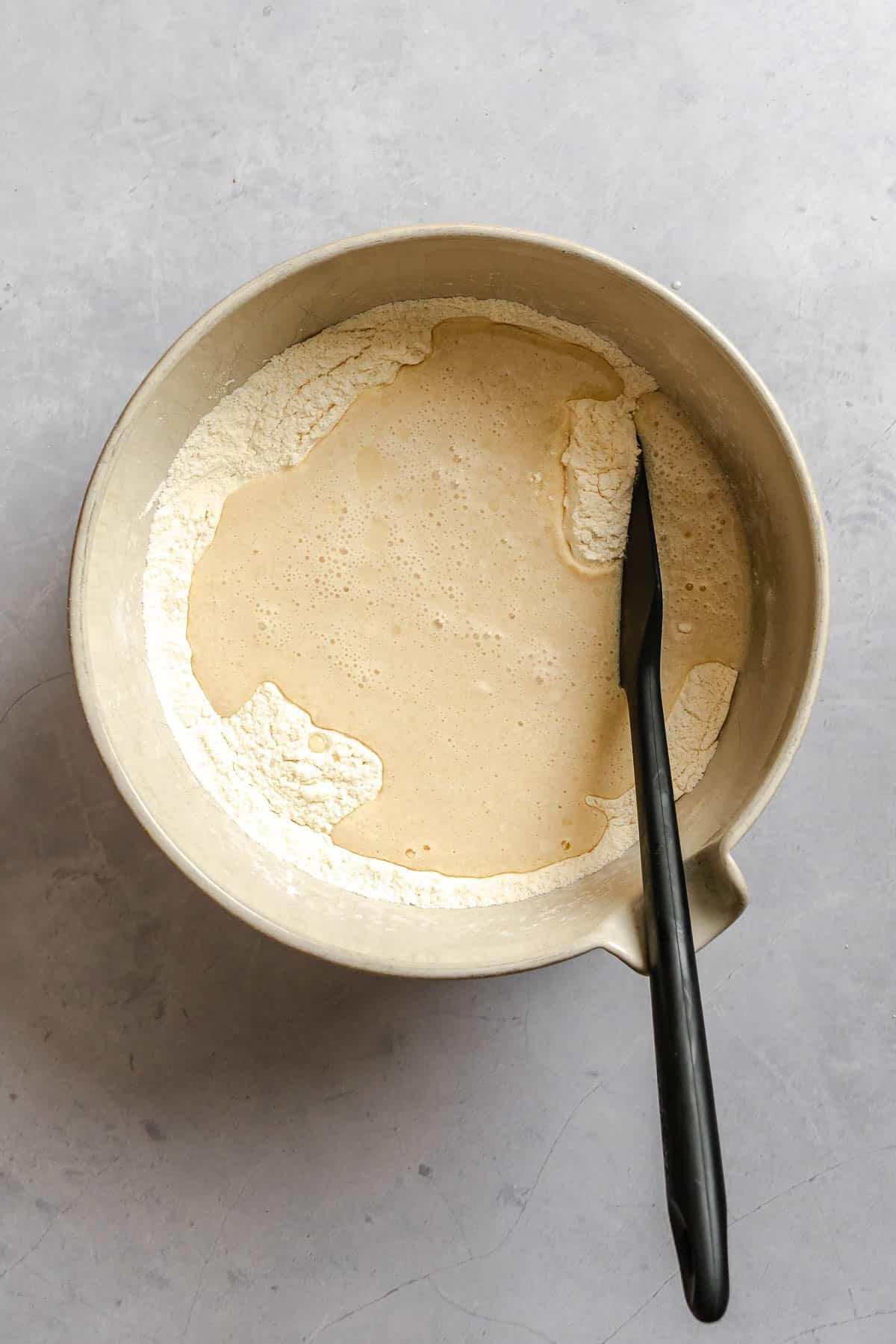 Process shot showing mixing ingredients in a bowl.