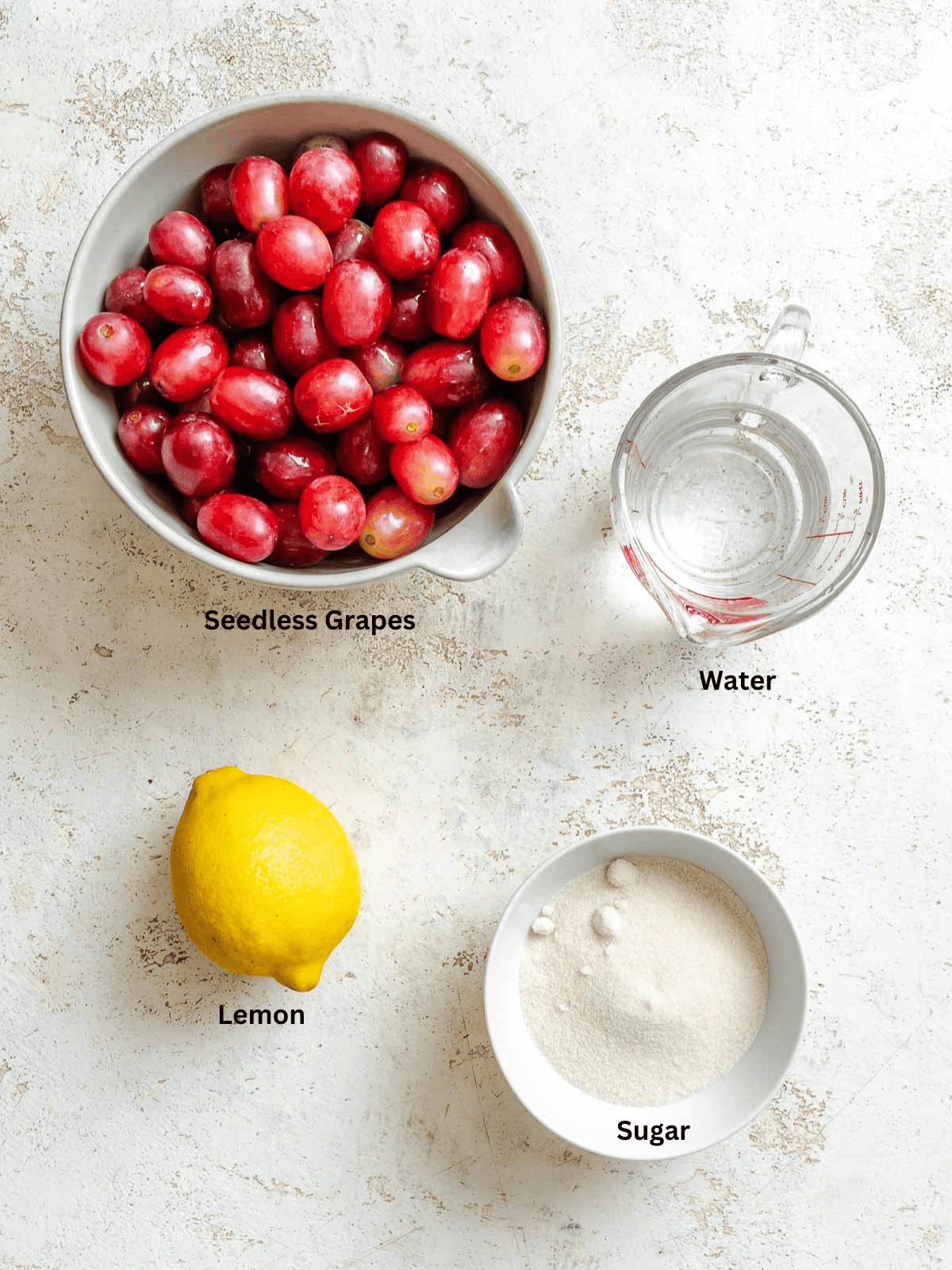 Ingredients for  Easy Grape Sorbet (Red or Green) measured out on a white surface. 