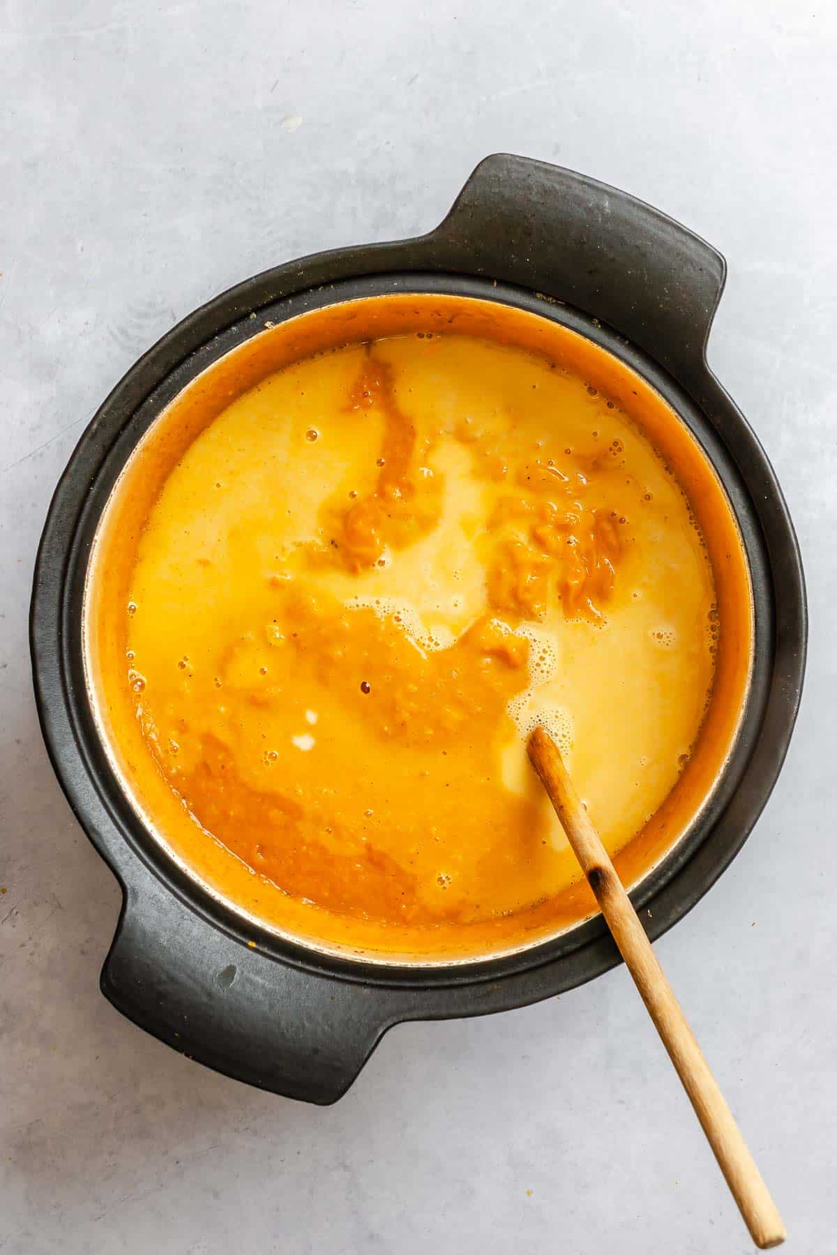 Process shot showing mixing ingredients in a bowl.