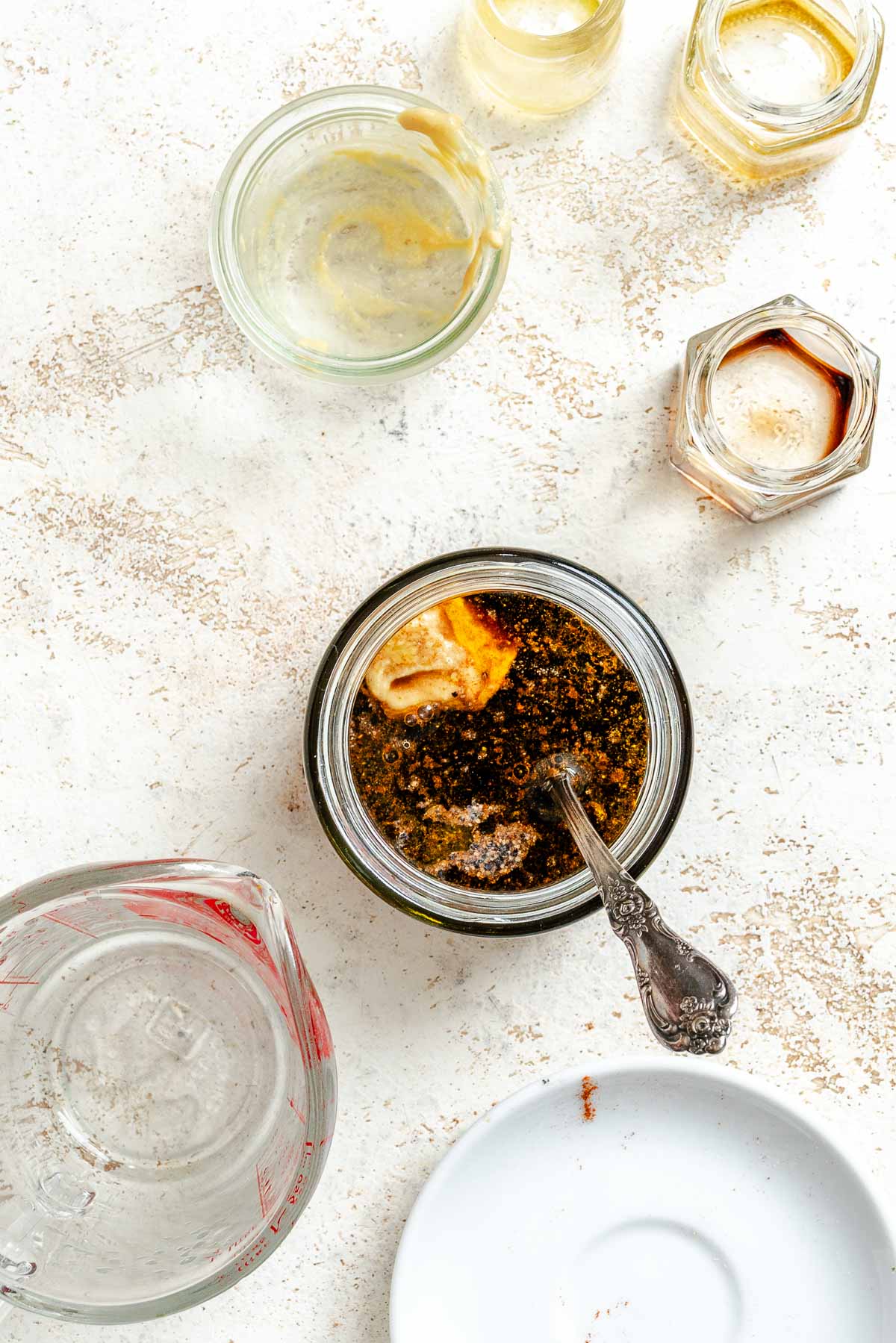 Process shot showing adding ingredients to a jar.