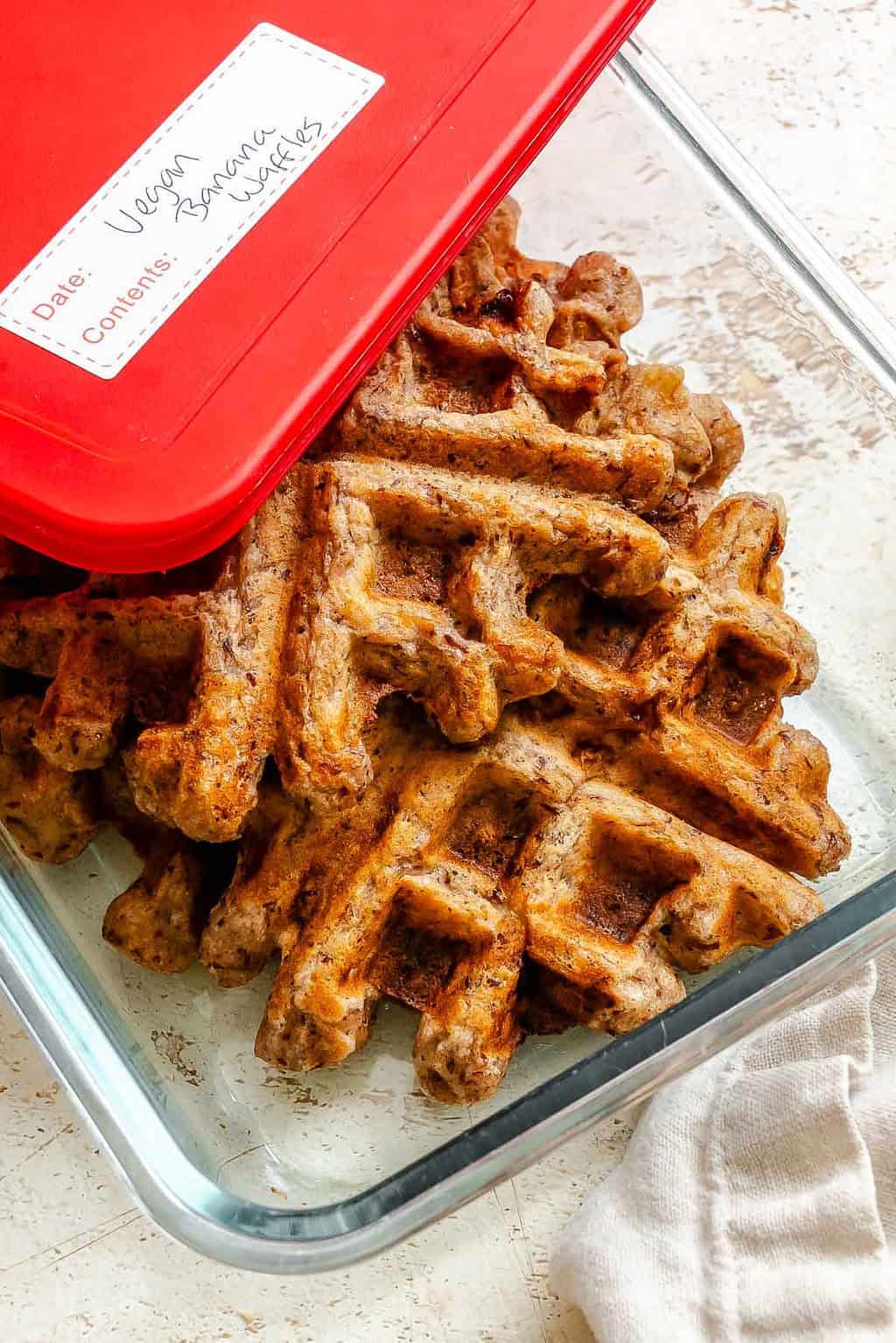 Completed Vegan Banana Waffles in a storage container.