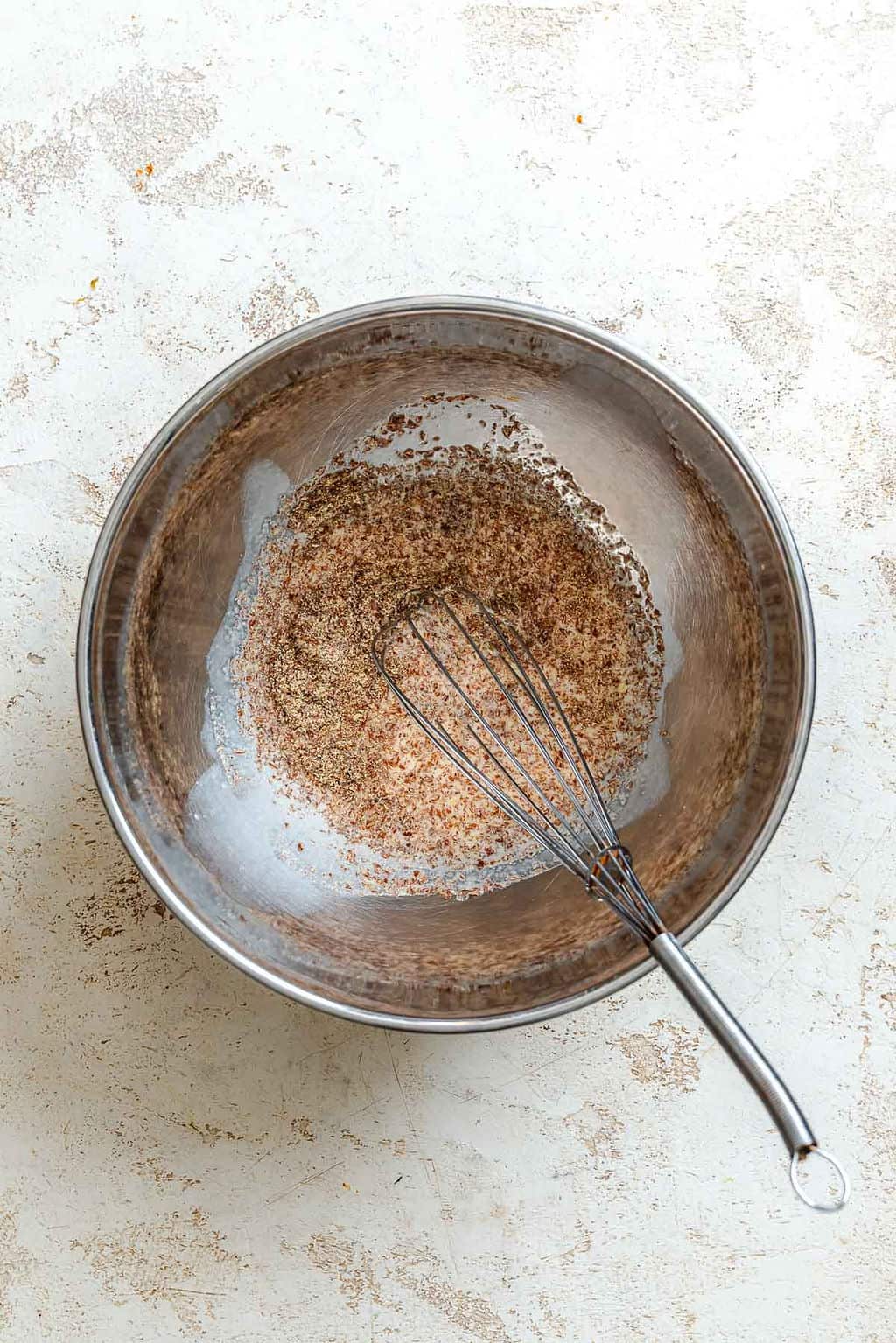 Process shot showing whisking ingredients in a bowl.