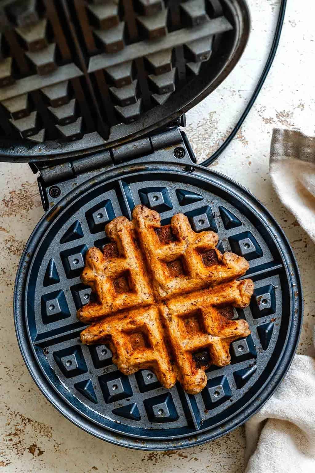 Process shot showing waffle cooking in waffle maker.