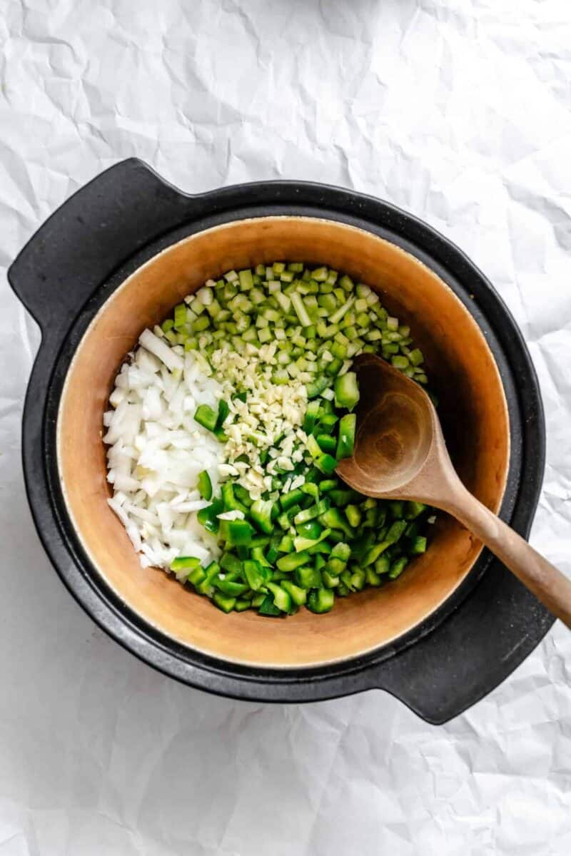Process shot showing mixing ingredients in pot.