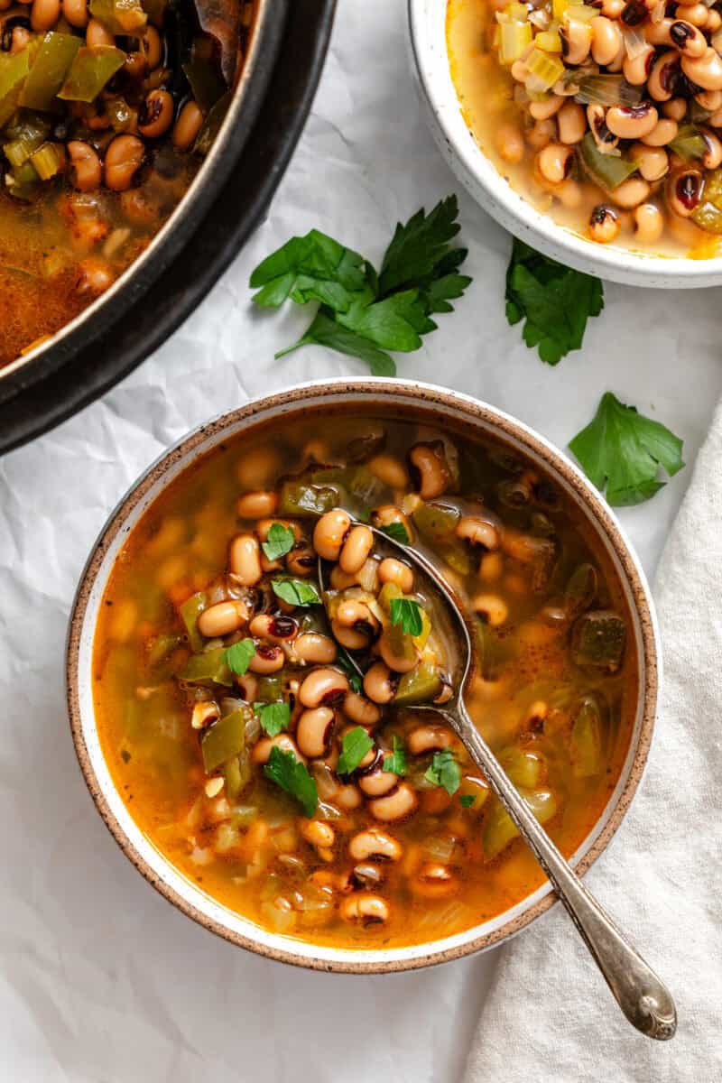 Completed Black Eyed Pea Soup (Vegan) in a bowl alongside pot.