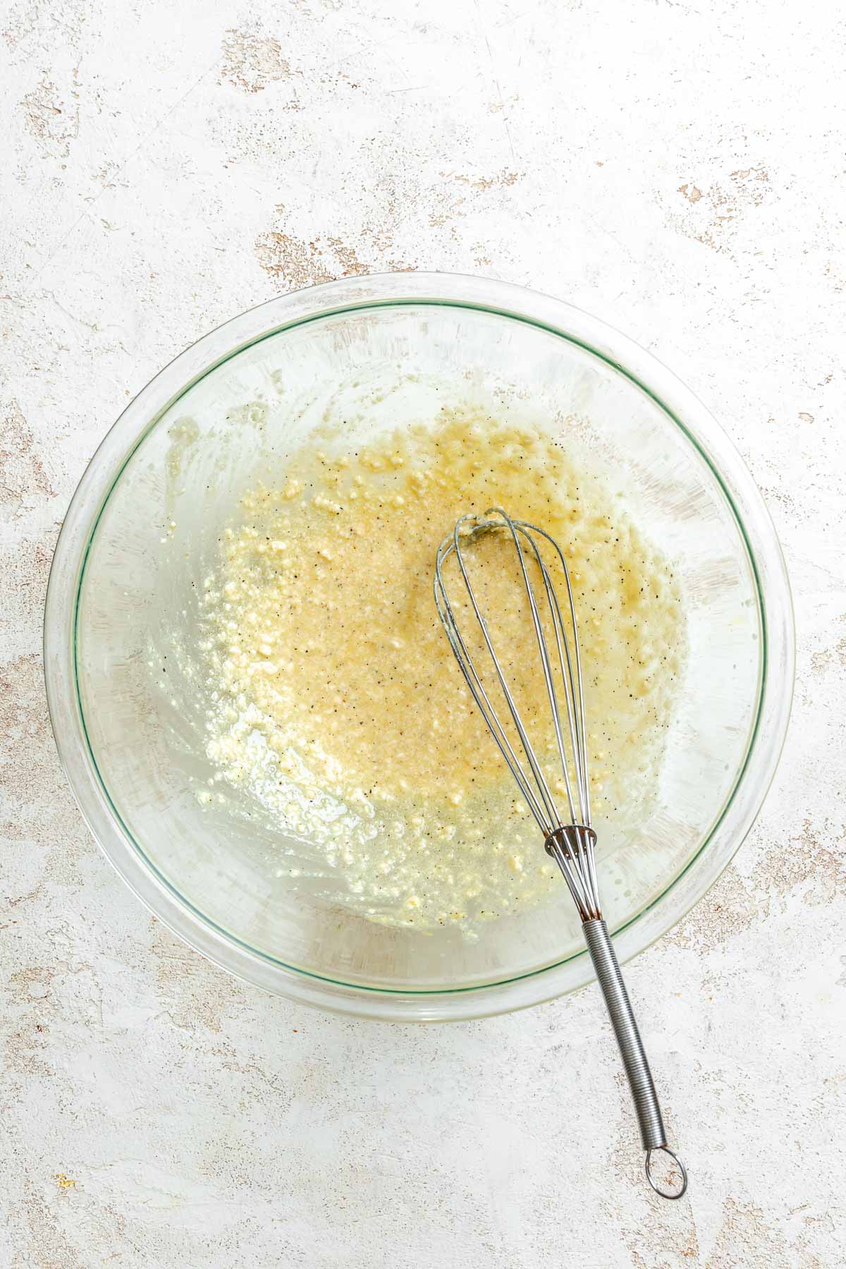 Process shot showing whisking ingredients together in a bowl.