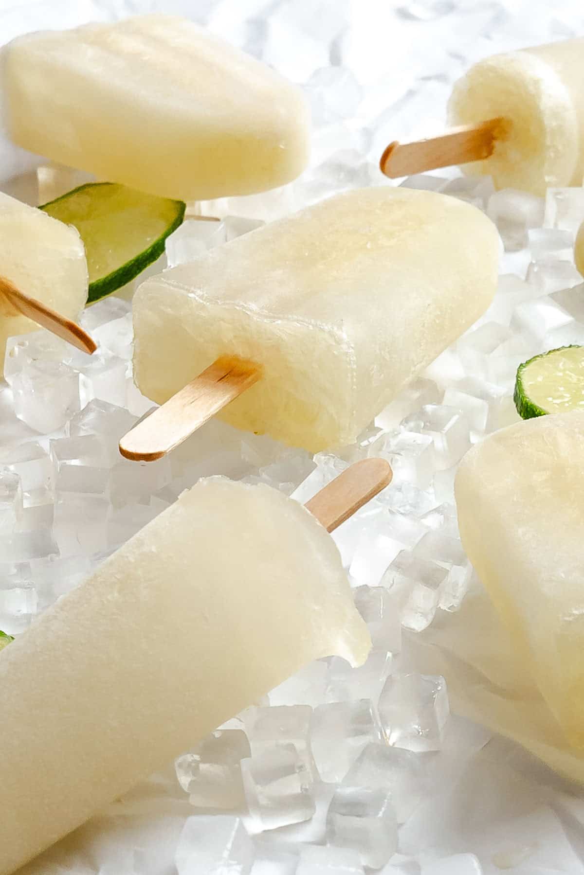 Several completed Easy Lime Popsicles on a white surface.
