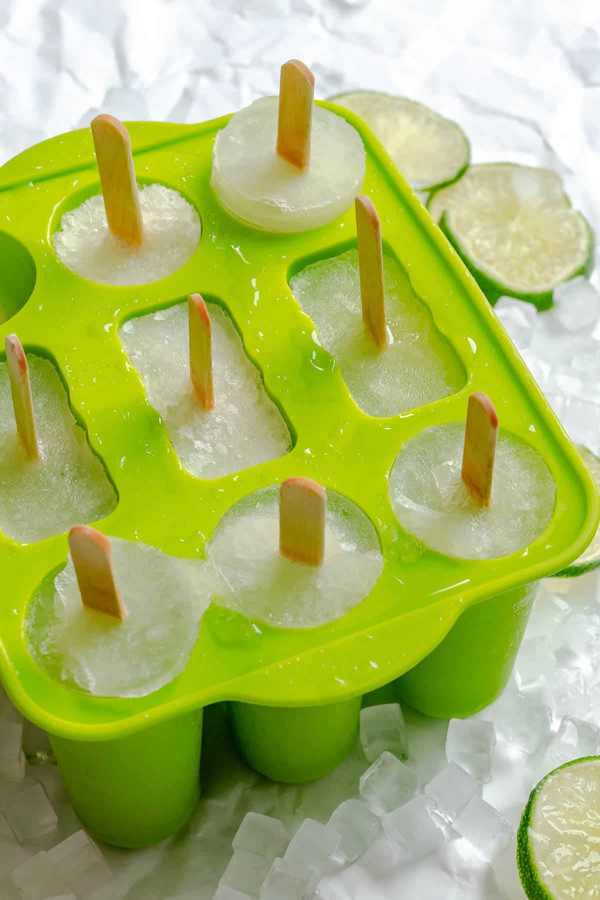 Several completed Easy Lime Popsicles in popsicle mold.