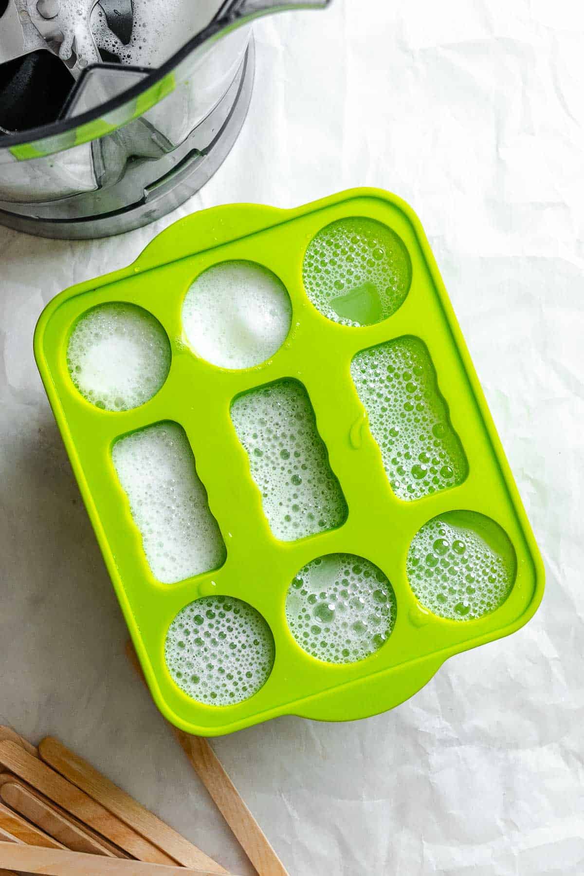 Process shot showing ingredients added to popsicle mold.