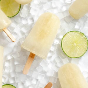Several completed Easy Lime Popsicles on a white surface.
