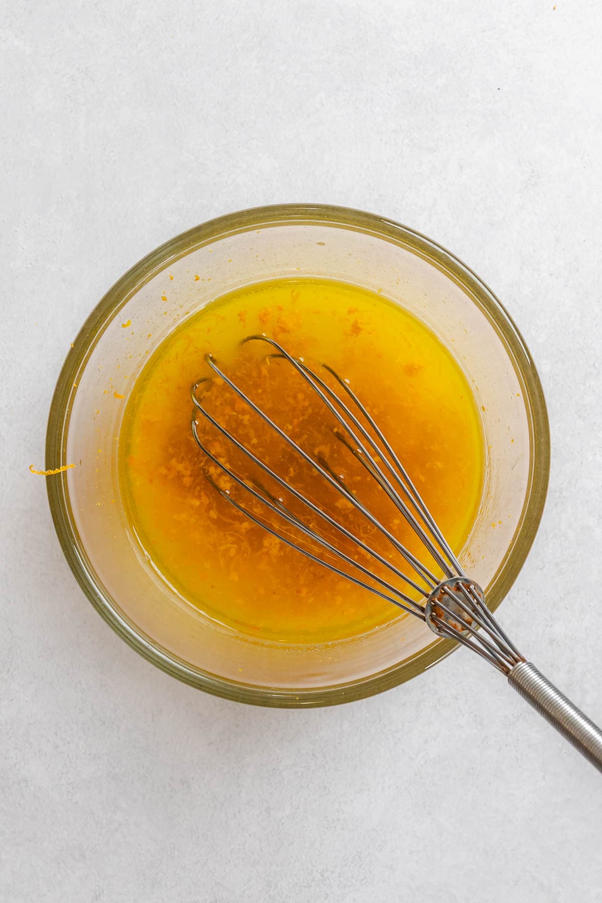 Process shot showing whisking ingredients in a bowl.