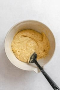 Process shot showing stirring ingredients in bowl.