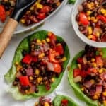 Several completed Vegetarian Lettuce Wraps (Beans & Corn) on a white surface.