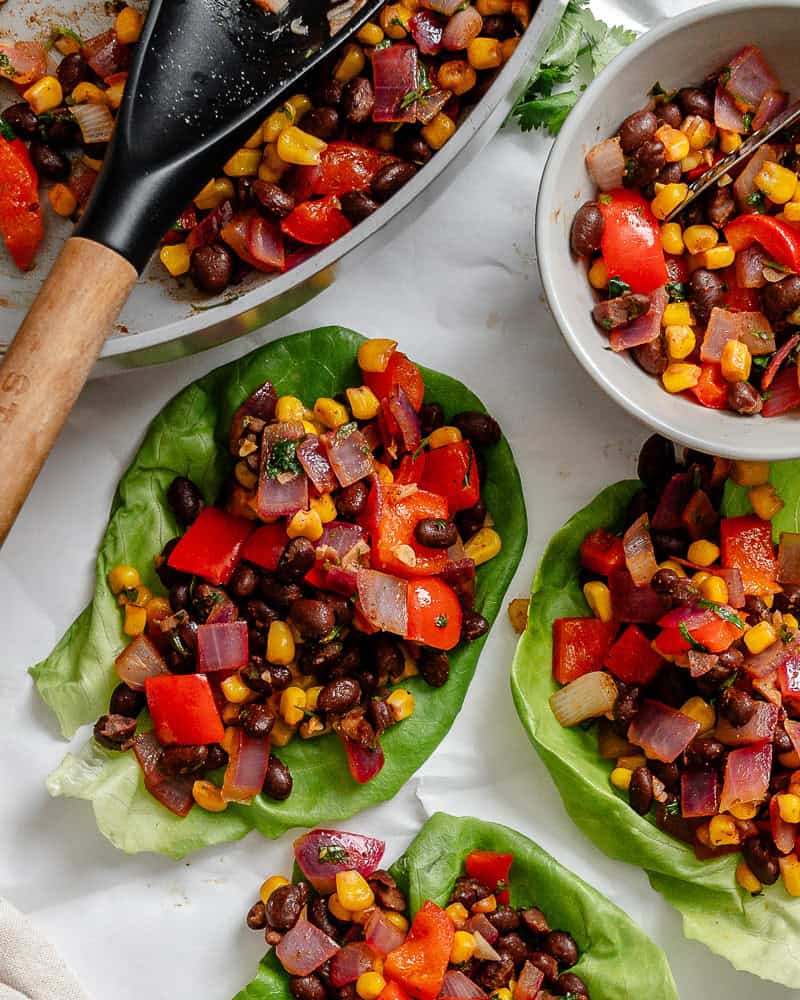 Several completed Vegetarian Lettuce Wraps (Beans & Corn) on a white surface.