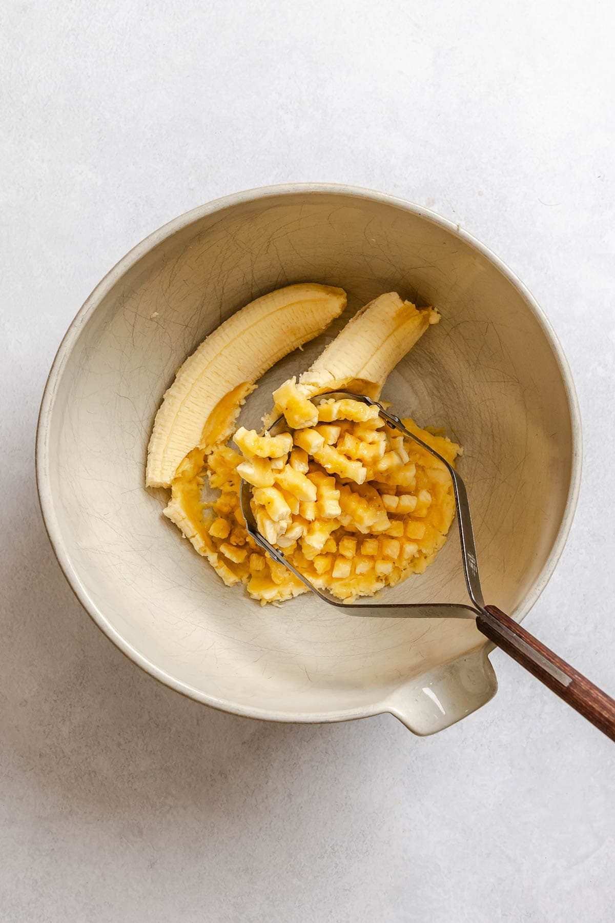 Process shot showing mashing bananas.