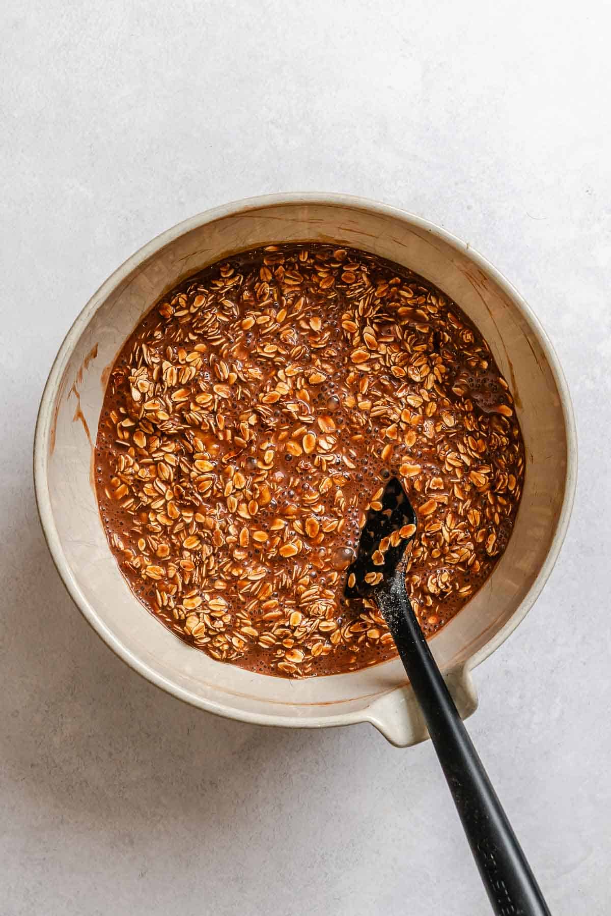 Process shot showing mixing ingredients in a bowl.