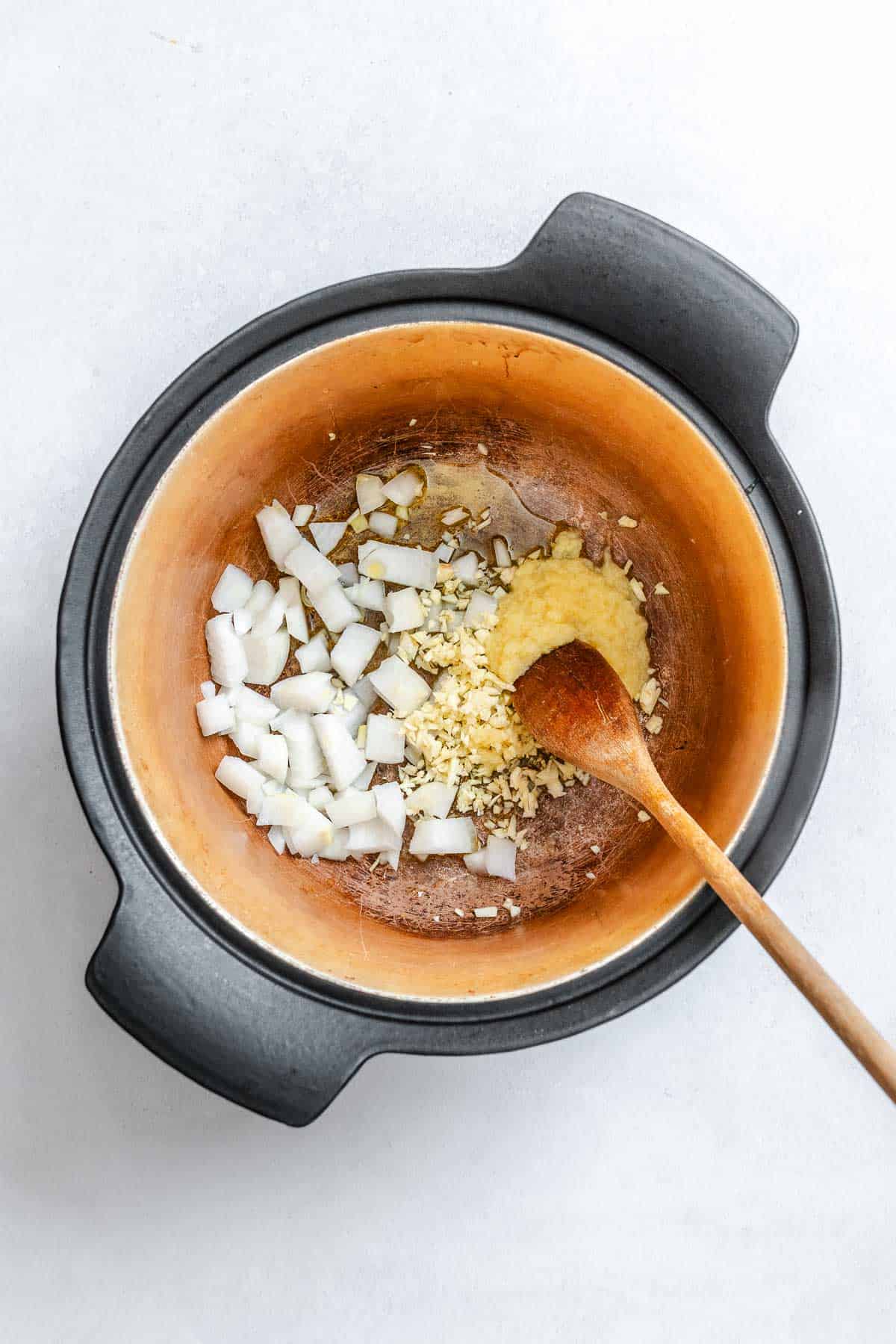 Process shot showing stirring ingredients in a pot.