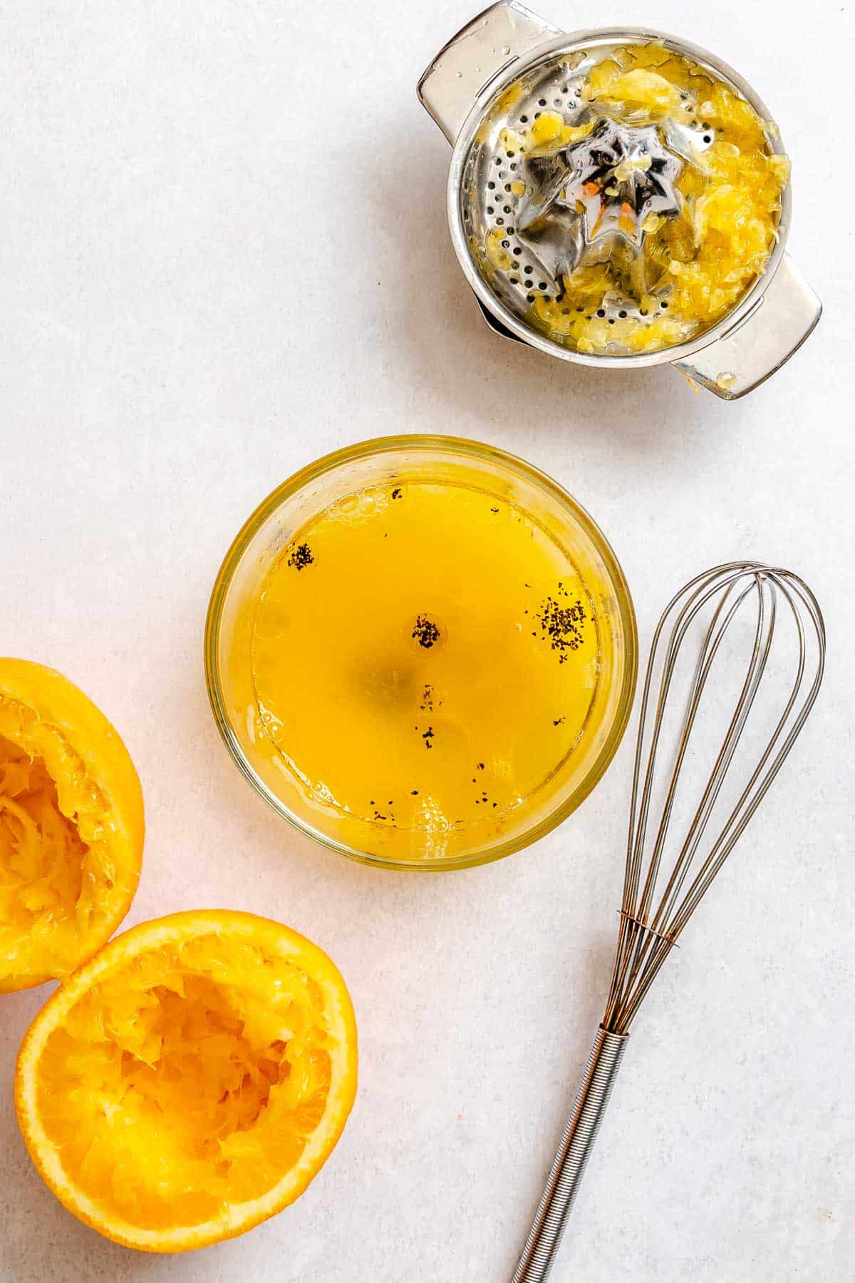 Process shot showing mixing dressing ingredients together in a bowl.