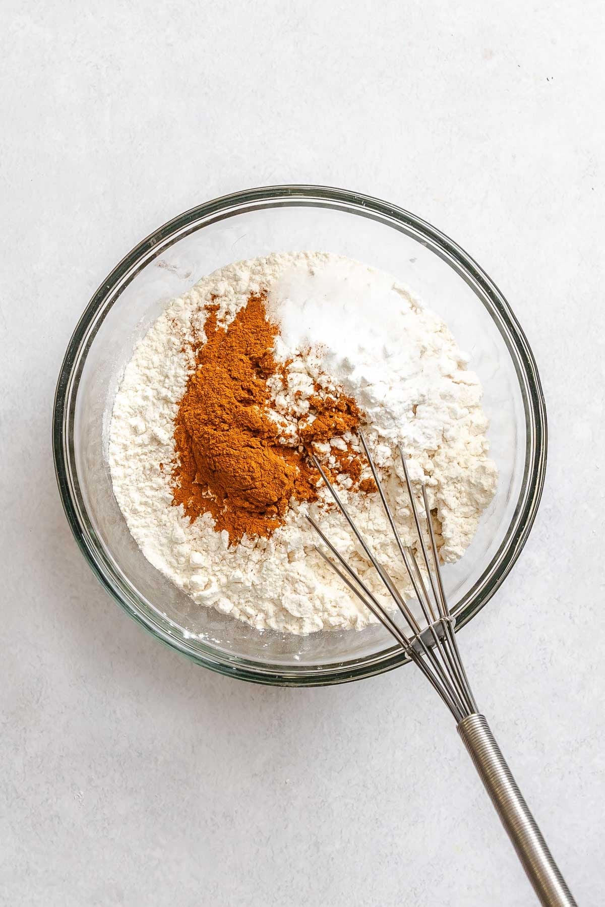 Process shot showing mixing ingredients in a bowl.