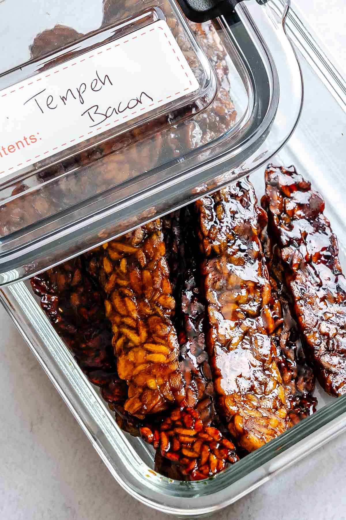 Completed Tempeh Bacon in a storage container.
