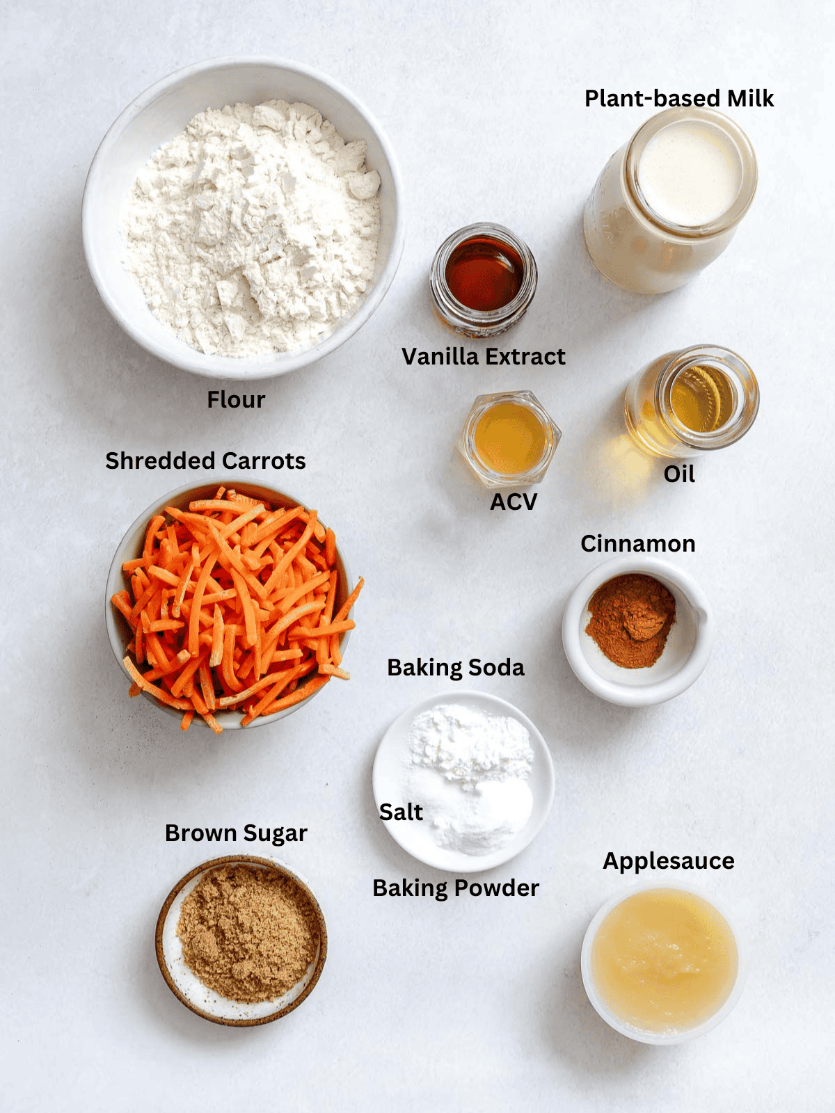 Ingredients for Carrot Cake Pancakes measured out on a white surface.