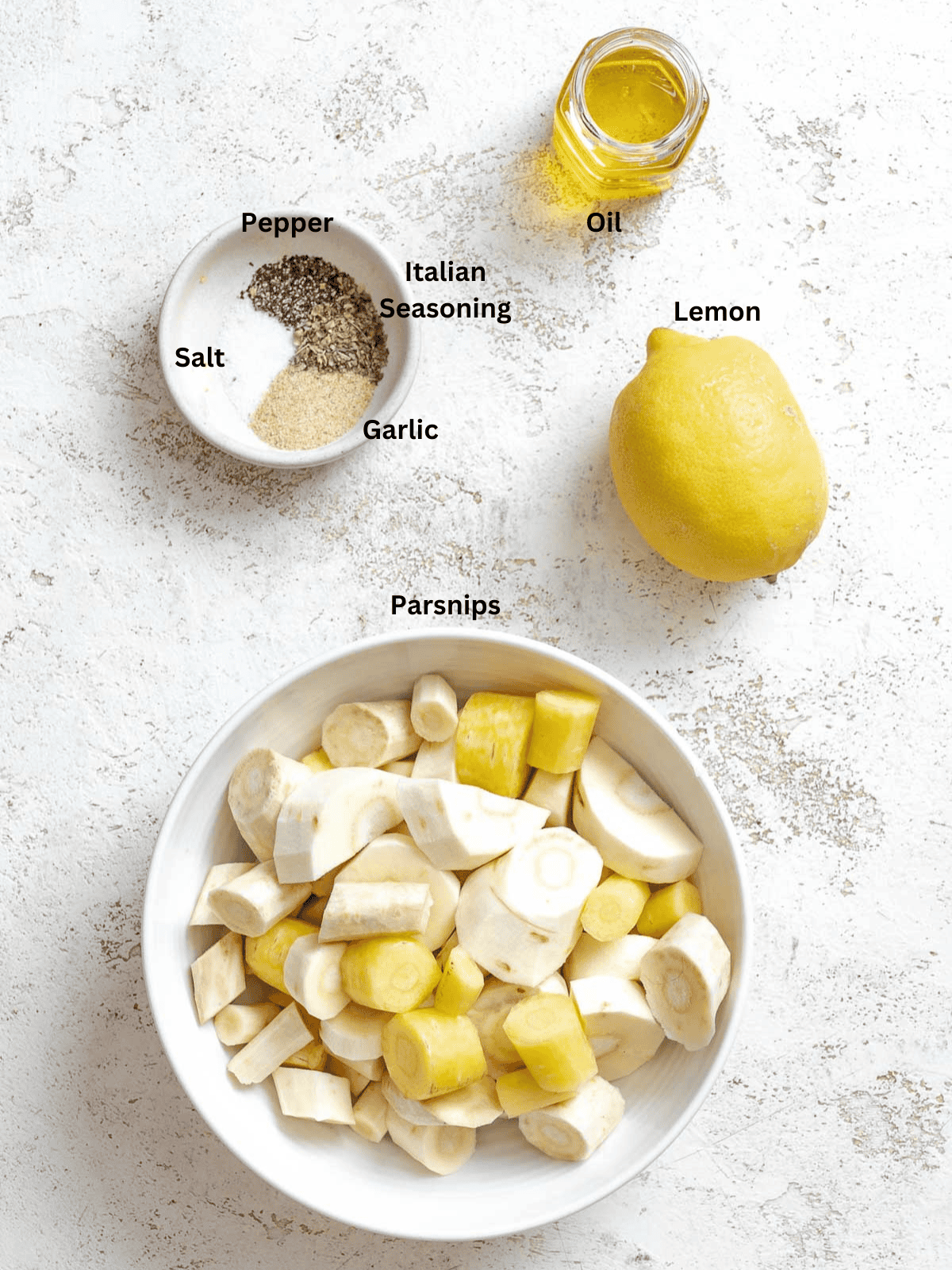 Ingredients for Roasted Parsnips measured out on a white surface.