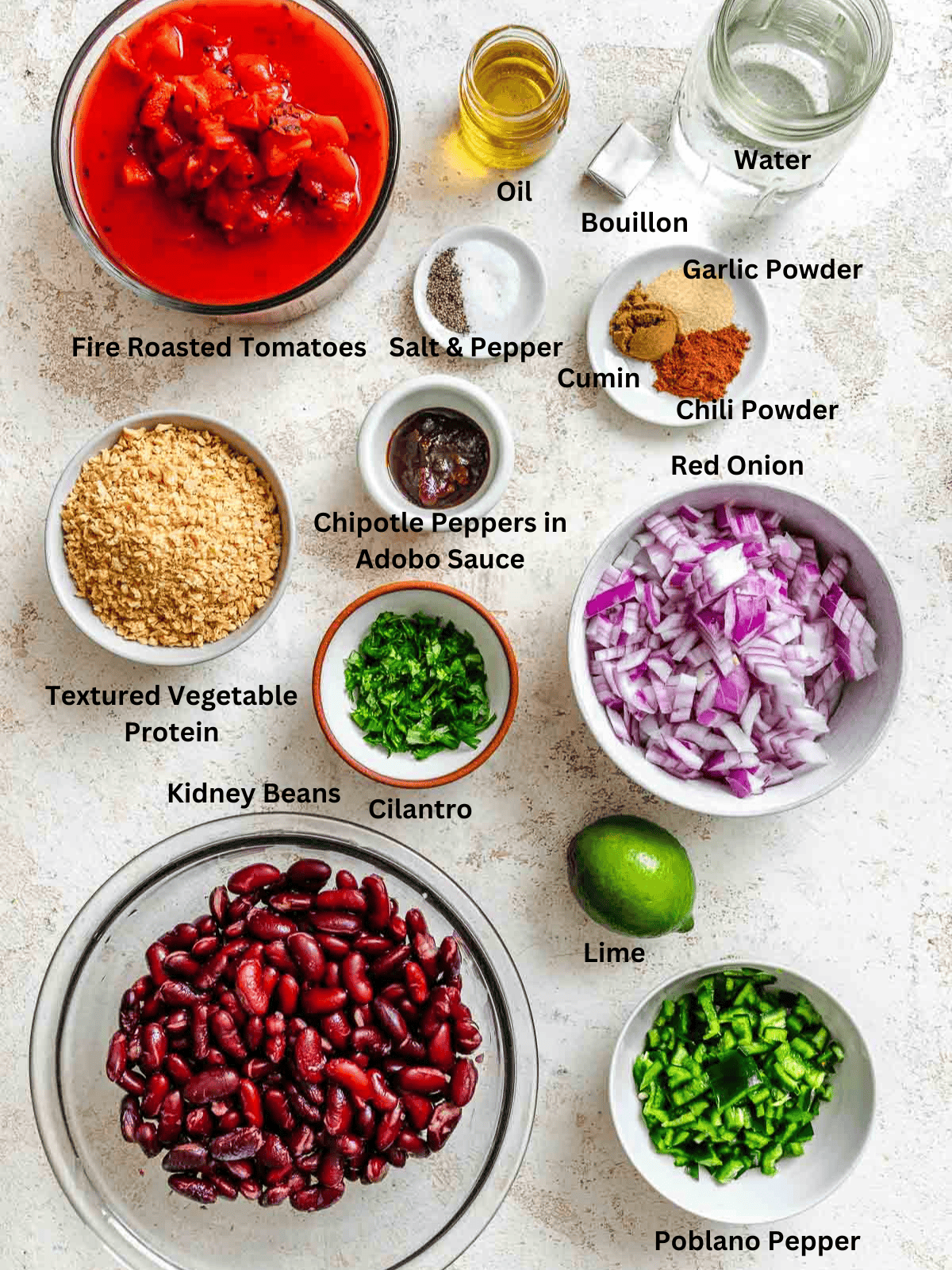 Ingredients for Chipotle Chili Recipe measured out on a white surface.
