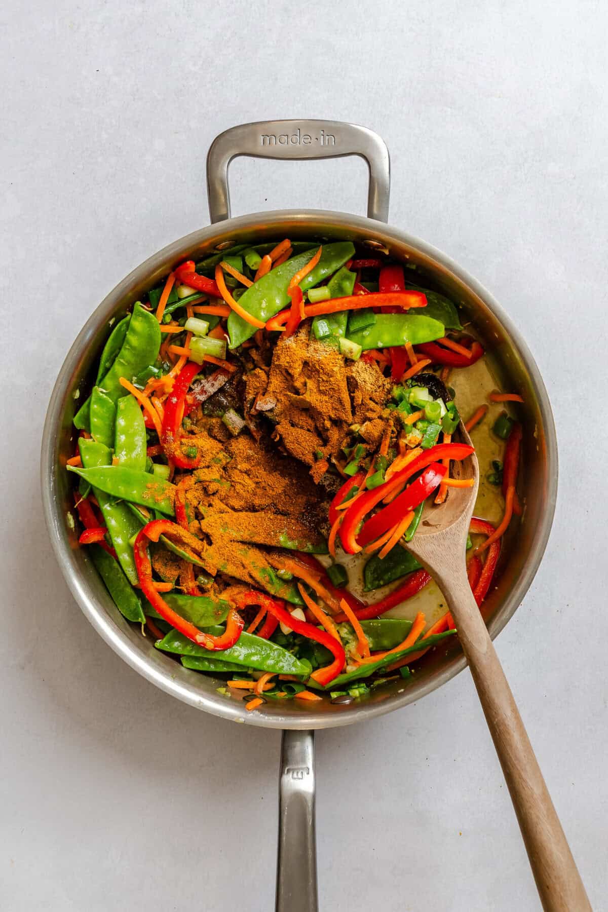 Process shot showing cooking ingredients in a pot.