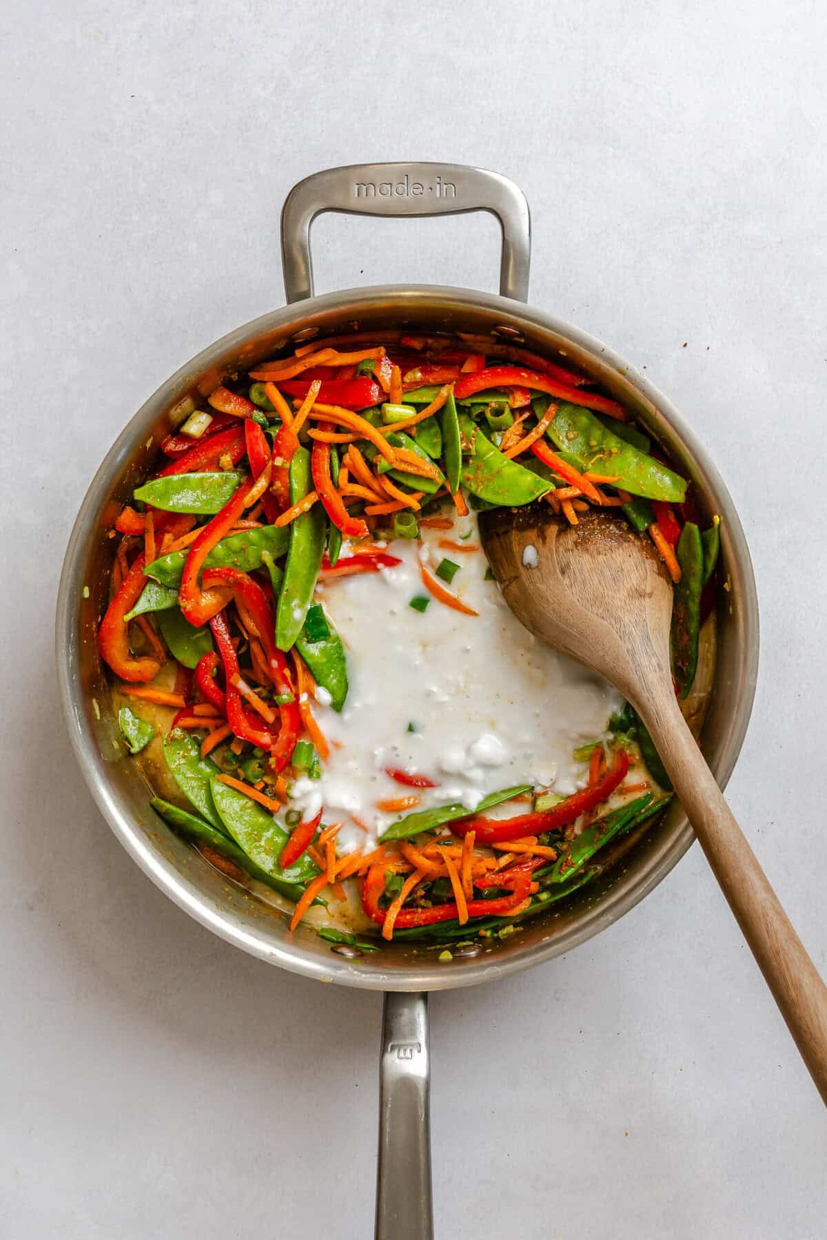 Process shot showing cooking ingredients in a pot.