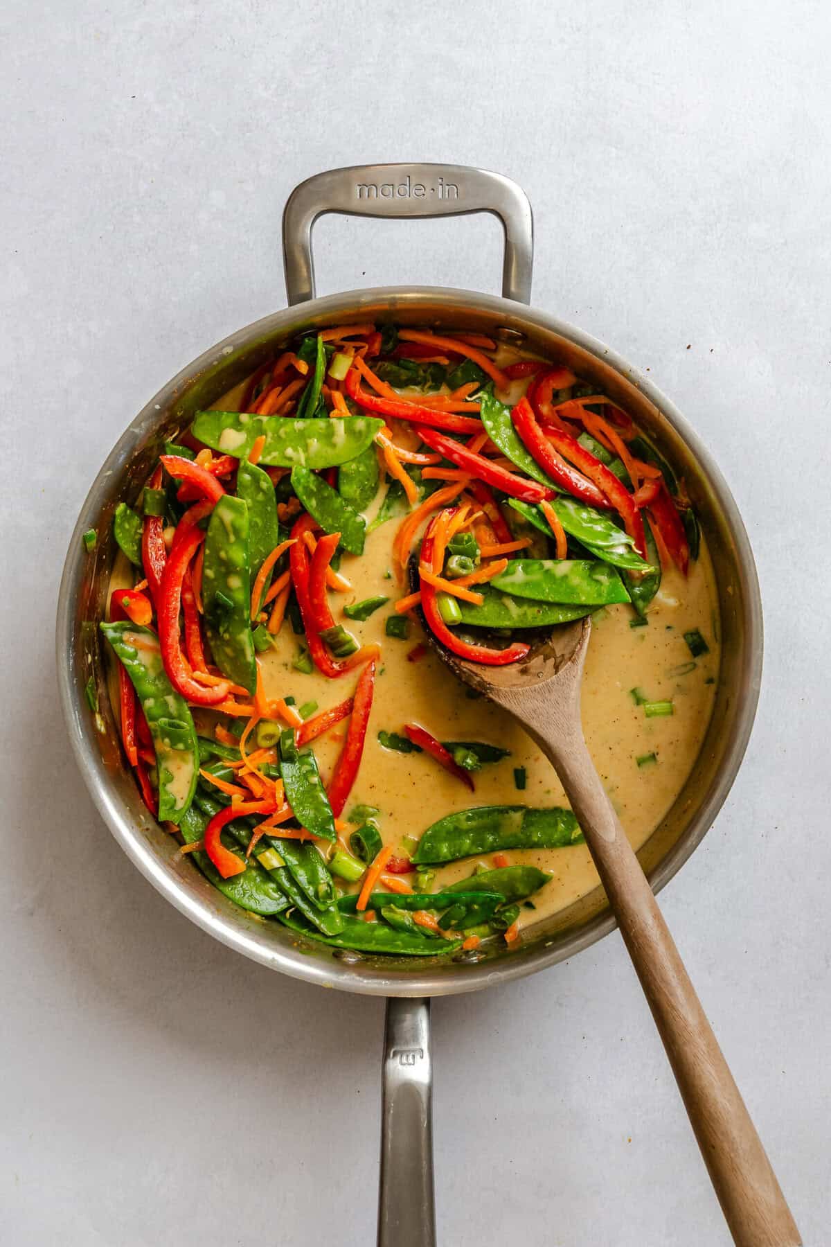 Process shot showing cooking ingredients in a pot.