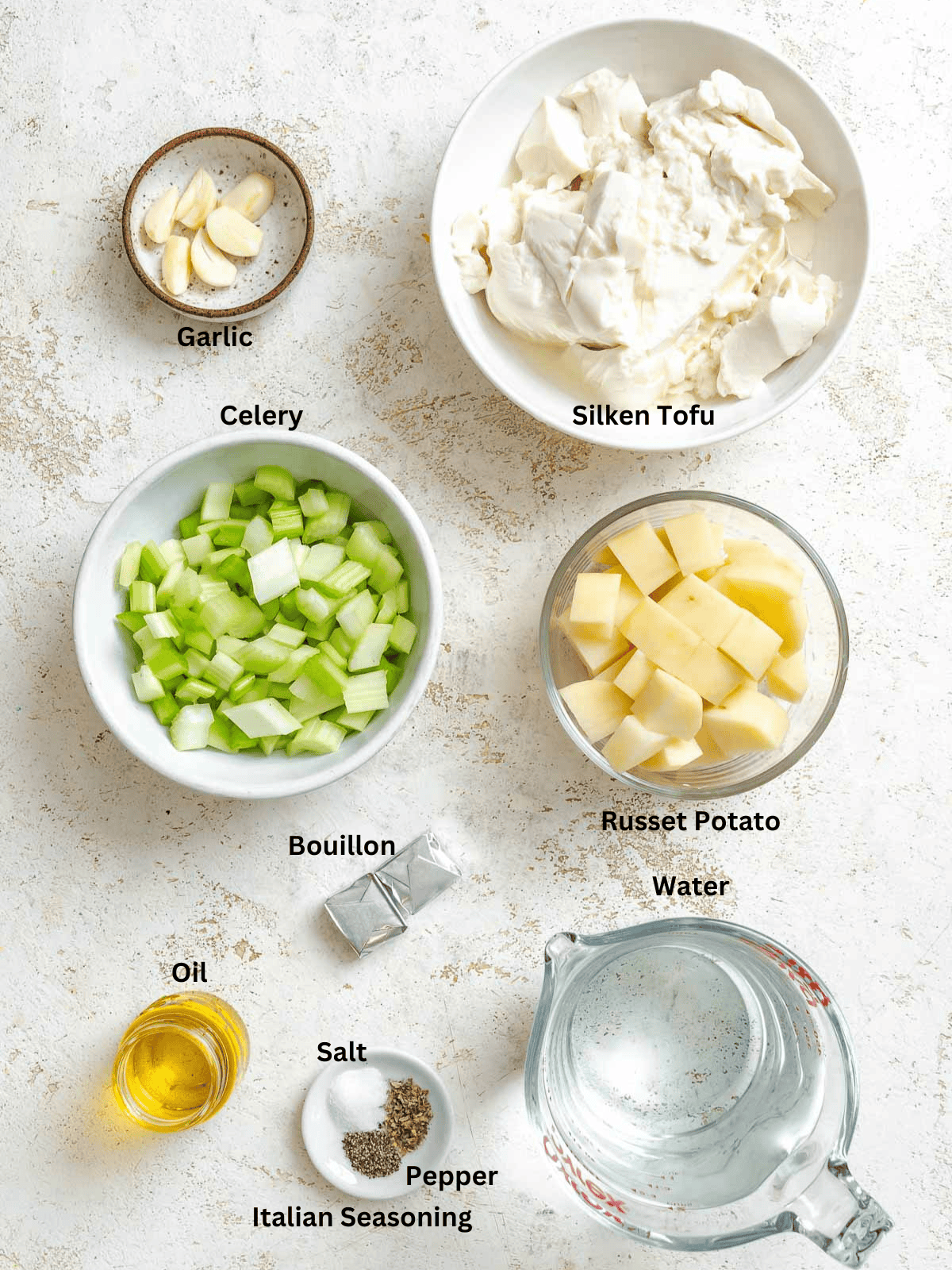 Ingredients for Cream of Celery Soup measured out on a white surface.