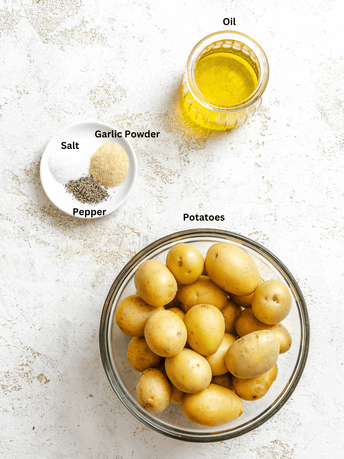Ingredients for Crispy Smashed Potatoes measured out on a white surface.
