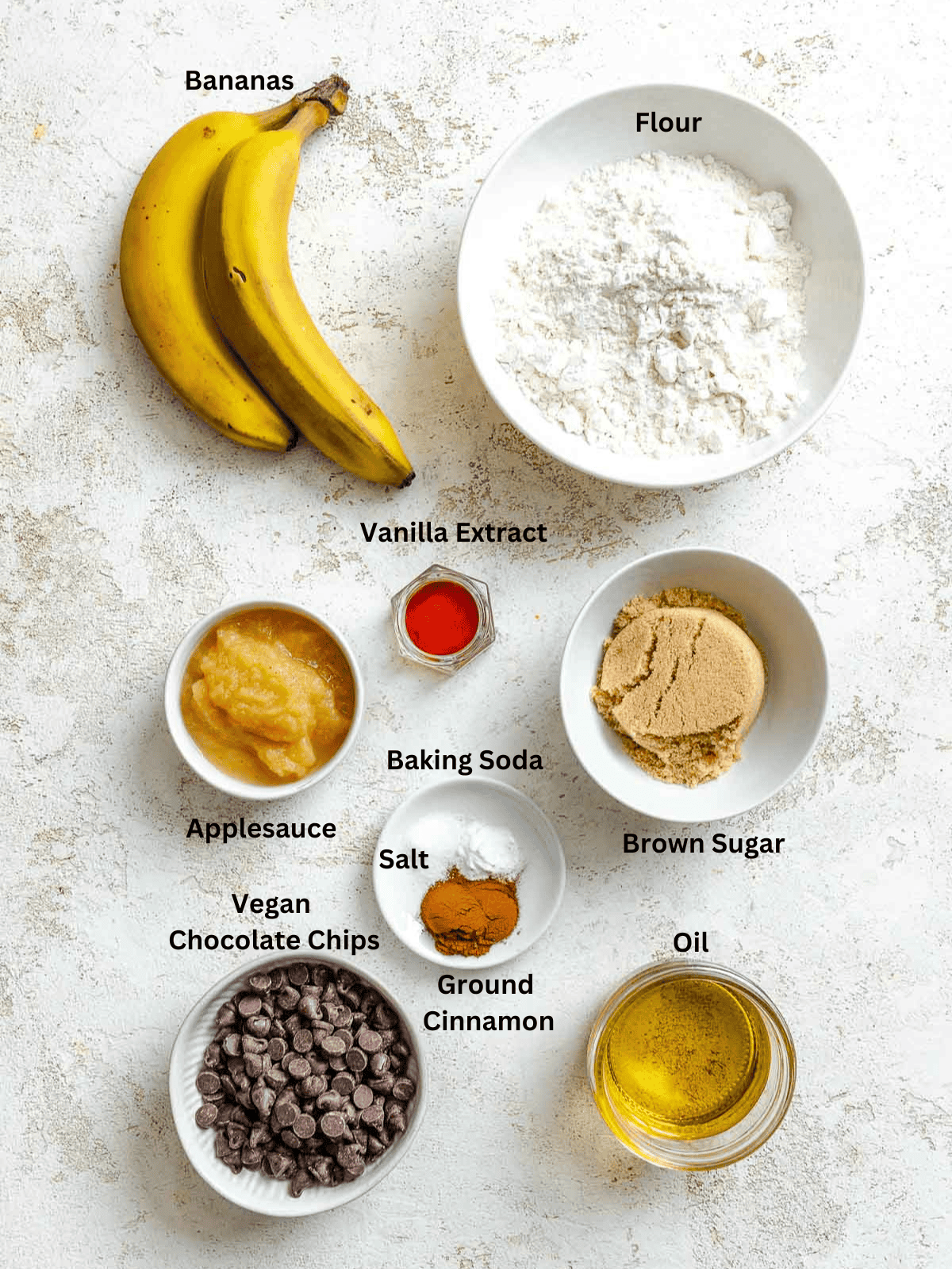 Ingredients for Banana Bread cookies measured out on a white surface.