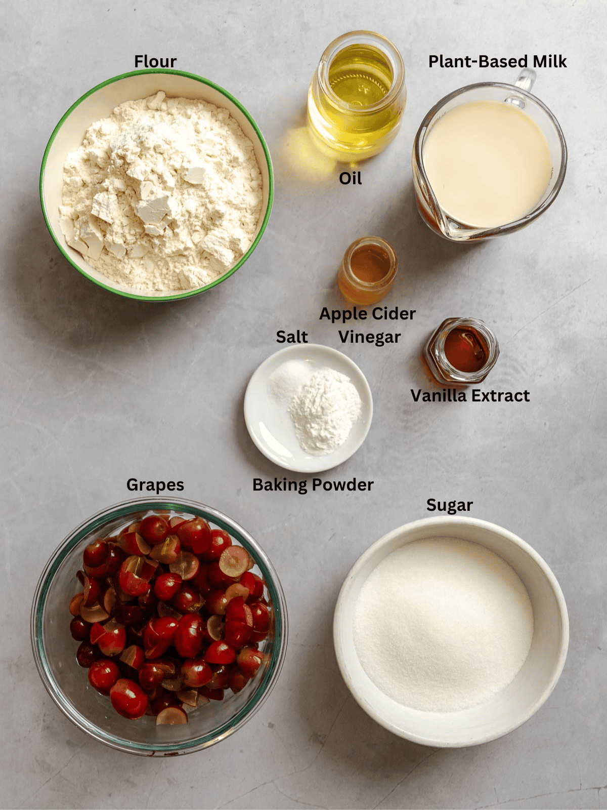 Ingredients for Grape Muffins (Egg-Free) measured out on a white surface.