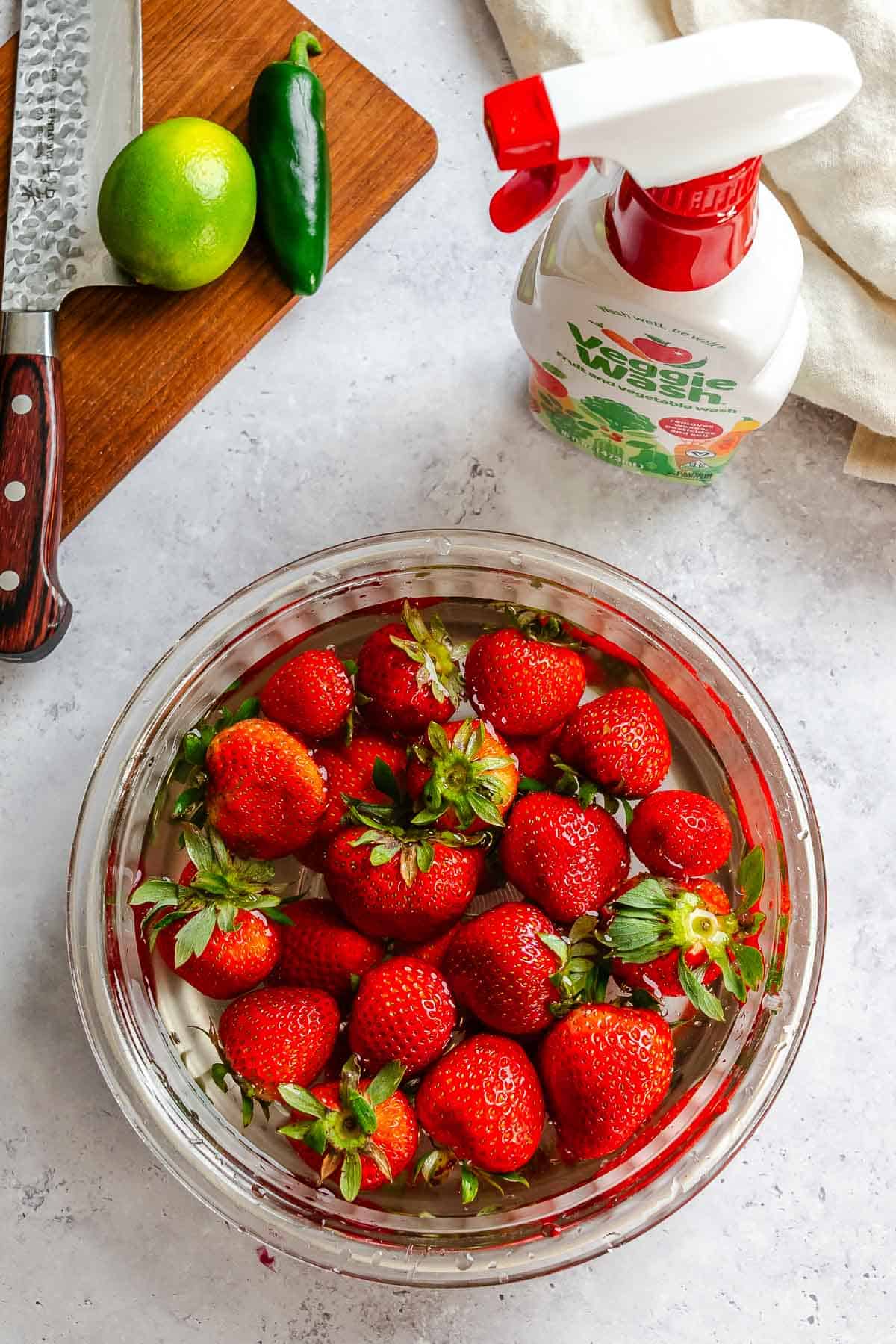 Photos of strawberries in a bowl alongside veggie wash.