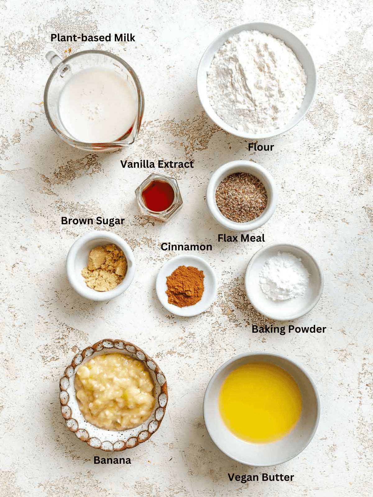 Ingredients for Vegan Banana Waffles measured out on a white surface.