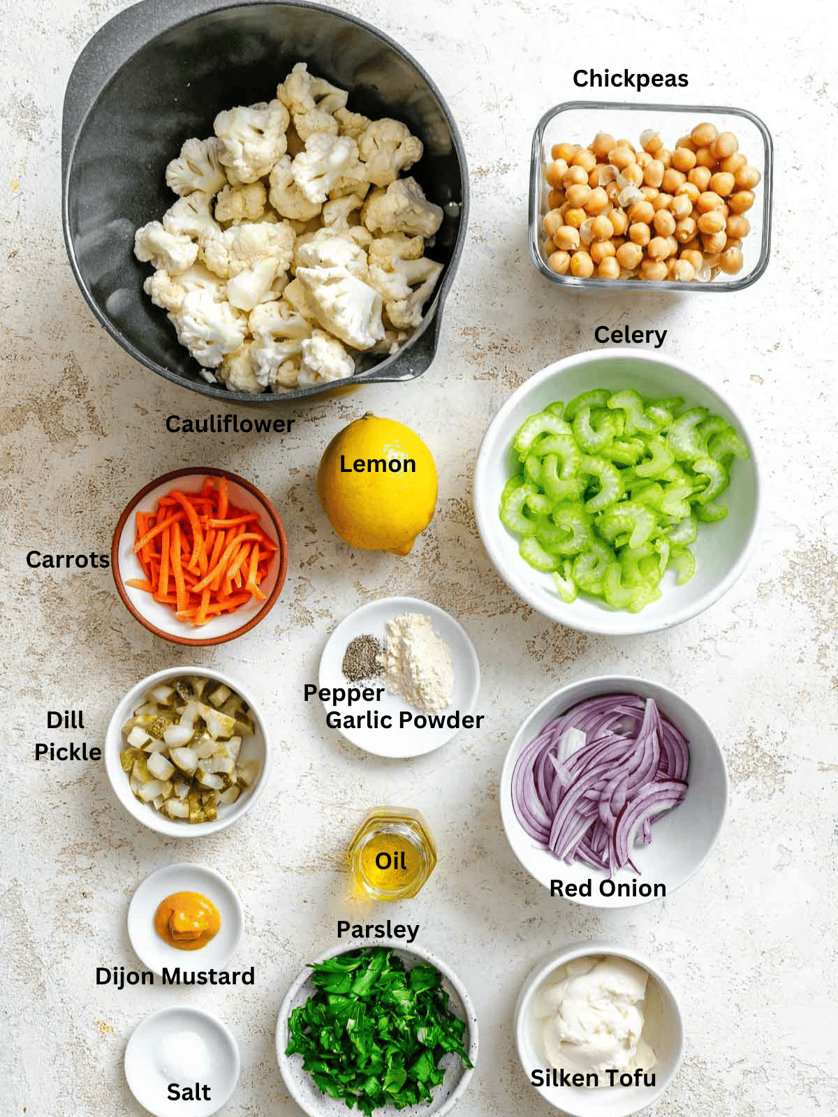 Ingredients for Cauliflower Salad measured out on a white surface.