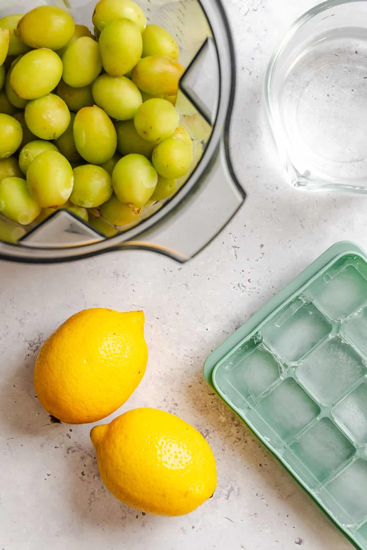 Ingredients for Grape Lemonade Slushie measured out on a white surface.