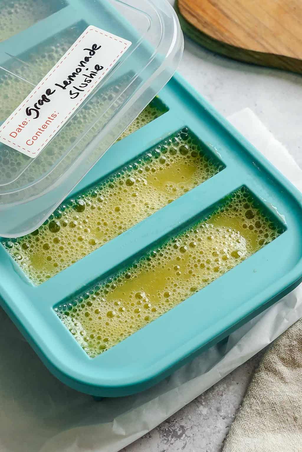 Completed Grape Lemonade Slushie in a storage container.