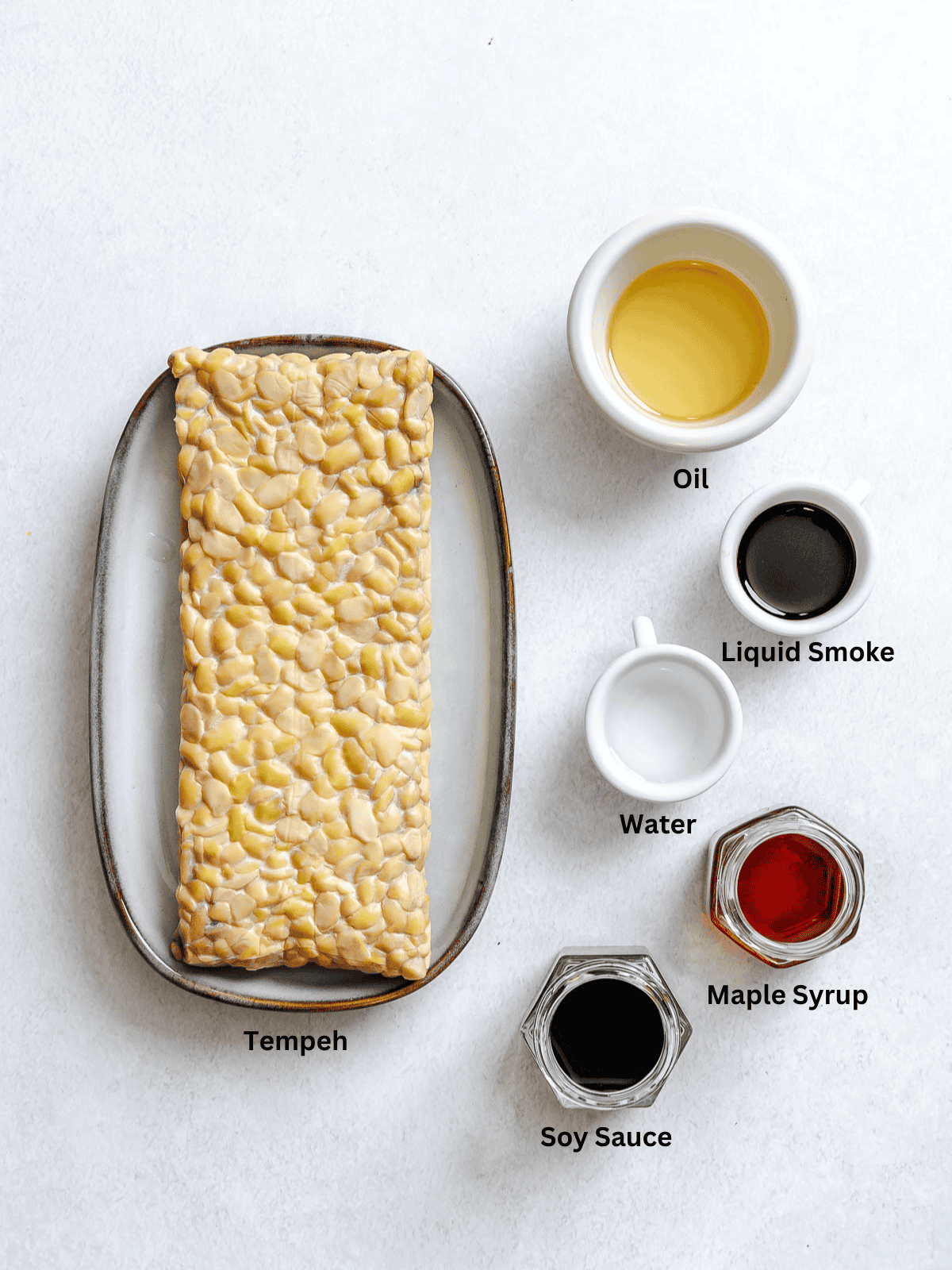 Ingredients for Tempeh Bacon measured out on a white surface.