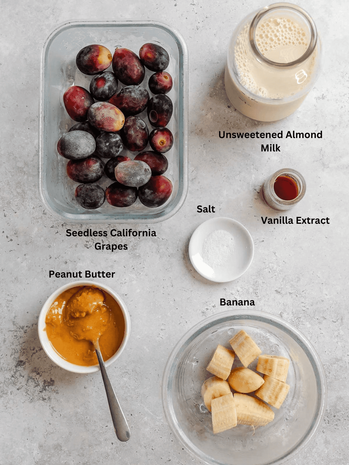 Ingredients for Peanut Butter & California Grapes Smoothie measured out on a white surface.