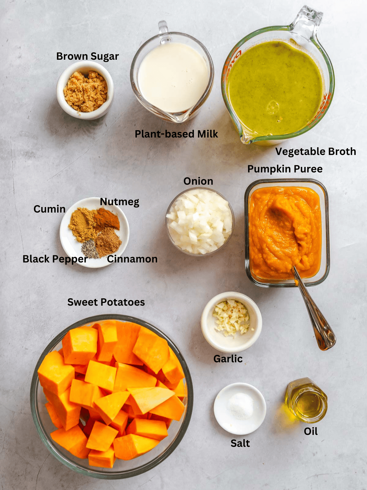 Ingredients for Sweet Potato Pumpkin Soup measured out on a white surface.
