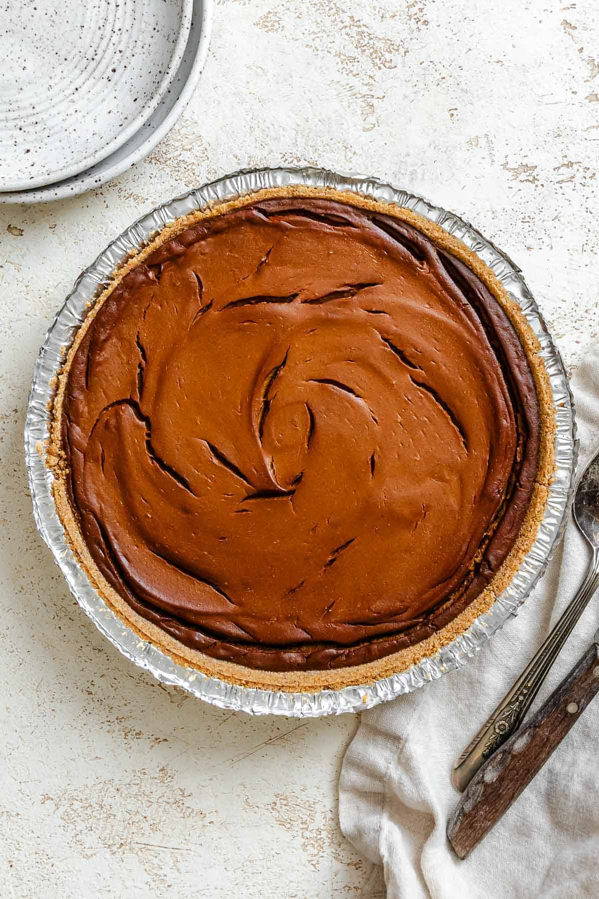 Baked vegan chocolate pumpkin pie in a pie dish.