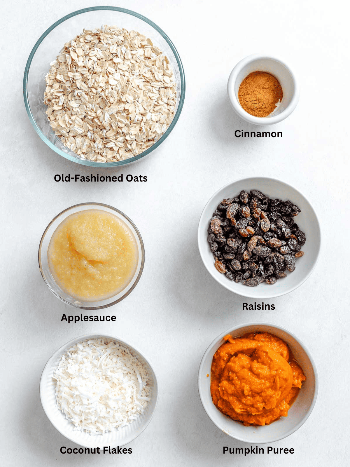 Ingredients for Oatmeal Pumpkin Bites measured out on a white surface.